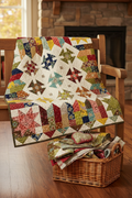 Kim Diehl Cute As A Button quilt kit draped over farmhouse bench in autumn light